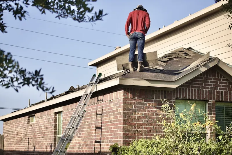 Professional roofer working on a residential roof in Wauregan Station